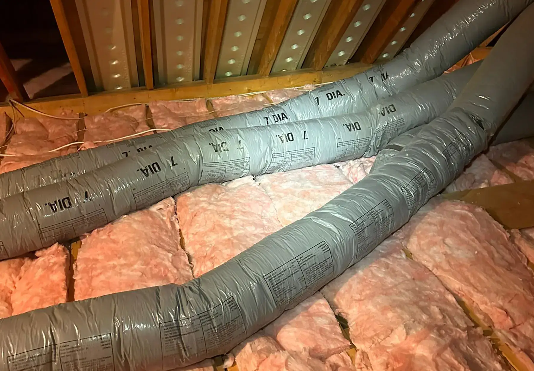 HVAC duct insulation installed in an attic space for proper ventilation and temperature control.