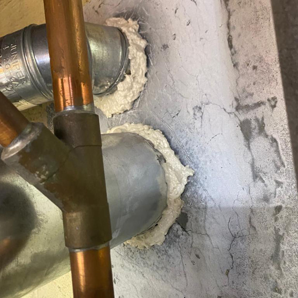 Image of a basement refurbished following the installation of foam insulation around ventilation pipes